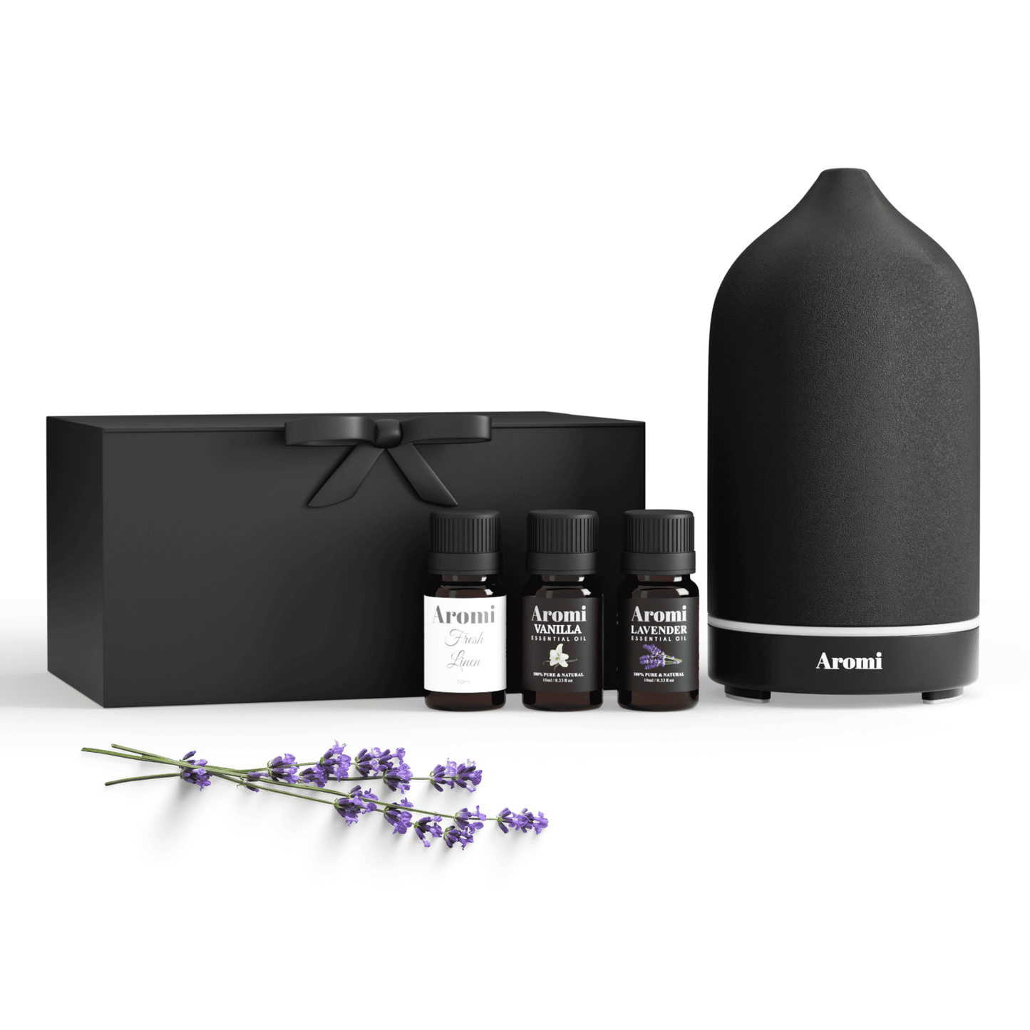 Svart diffuser och 3 eteriska oljor, frontvy vit bakgrund