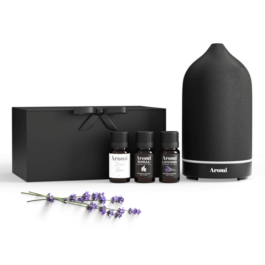 Svart diffuser och 3 eteriska oljor, frontvy vit bakgrund